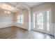 Bright dining area with wainscoting, coffered ceilings, and large windows at 920 Sublime Trl, Canton, GA 30114