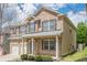 Side view of a brick home with two-car garage, landscaped garden, and neutral siding at 920 Sublime Trl, Canton, GA 30114