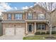 Charming two-story brick home with a two-car garage and manicured front lawn at 920 Sublime Trl, Canton, GA 30114