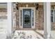 Close-up of a stylish gray front door with decorative glass and sidelights at 920 Sublime Trl, Canton, GA 30114