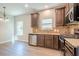 Kitchen featuring stainless appliances, stone countertops, and dark wood cabinets at 920 Sublime Trl, Canton, GA 30114