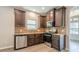 Kitchen featuring stainless appliances, stone countertops, and dark wood cabinets at 920 Sublime Trl, Canton, GA 30114