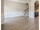Spacious living area with hardwood floors, wainscoting, staircase, and open floor plan at 920 Sublime Trl, Canton, GA 30114
