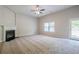 Spacious living room featuring a fireplace, ceiling fan, neutral paint, and plenty of natural light at 920 Sublime Trl, Canton, GA 30114