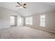 The large carpeted main bedroom has a ceiling fan, two windows, and an open closet at 920 Sublime Trl, Canton, GA 30114