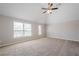 Large carpeted main bedroom features a ceiling fan and two bright windows at 920 Sublime Trl, Canton, GA 30114