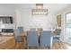 Elegant dining room with a modern chandelier, decorative wall panel, and seating for six at 470 Oriole Dr, Marietta, GA 30067