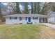 Charming single-story home with blue shutters and door, manicured front lawn at 470 Oriole Dr, Marietta, GA 30067