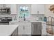 Bright kitchen with white cabinetry, stainless steel appliances, and subway tile backsplash at 470 Oriole Dr, Marietta, GA 30067