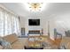 Comfortable living room with fireplace, modern lighting, open to the dining area at 470 Oriole Dr, Marietta, GA 30067