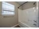 Clean bathroom with a tub-shower combo and a bright window at 718 Dalvigney Nw St, Atlanta, GA 30318