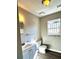 Cozy bathroom features a modern vanity, toilet, and neutral gray walls at 718 Dalvigney Nw St, Atlanta, GA 30318
