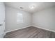 Cozy bedroom with natural light, featuring hardwood floors and neutral walls at 718 Dalvigney Nw St, Atlanta, GA 30318