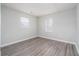 Cozy bedroom features neutral walls, gray wood flooring, and natural lighting at 718 Dalvigney Nw St, Atlanta, GA 30318
