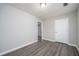 Well-lit bedroom showcasing hardwood floors, neutral paint, and closet space at 718 Dalvigney Nw St, Atlanta, GA 30318