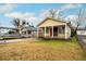 Quaint yellow home with a cozy front porch and a spacious front yard at 718 Dalvigney Nw St, Atlanta, GA 30318