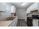 Efficient kitchen featuring white cabinets, butcher block countertops, and black appliances at 718 Dalvigney Nw St, Atlanta, GA 30318