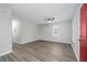 Spacious living room featuring gray wood floors, a ceiling fan, and a bright, airy feel at 718 Dalvigney Nw St, Atlanta, GA 30318