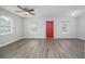 Bright and airy living room with modern gray wood floors, a ceiling fan, and ample windows at 718 Dalvigney Nw St, Atlanta, GA 30318