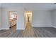 Bright living room showcasing gray wood floors and an open layout to the kitchen at 718 Dalvigney Nw St, Atlanta, GA 30318