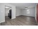 Open-concept living area with gray wood floors, ceiling fan, and a view of the kitchen at 718 Dalvigney Nw St, Atlanta, GA 30318