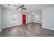 Open living area featuring gray wood floors, a ceiling fan, and natural light from the windows at 718 Dalvigney Nw St, Atlanta, GA 30318