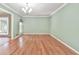 Spacious living room featuring hardwood floors, crown molding, and calming green walls at 2614 Club Valley Ne Dr, Marietta, GA 30068