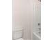 A white bathroom features a shower-tub combo and a neutral color palette at 290 Halibut Cir, Covington, GA 30016