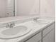A bathroom features a marble-look countertop with double vanity sinks at 290 Halibut Cir, Covington, GA 30016