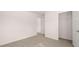 A carpeted bedroom features a walk-in closet and a view to another room at 290 Halibut Cir, Covington, GA 30016