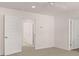 A bedroom with neutral walls and carpet, featuring two white doors and a ceiling fan at 290 Halibut Cir, Covington, GA 30016