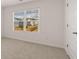 A bedroom with neutral carpet and natural light features a view of the outside at 290 Halibut Cir, Covington, GA 30016