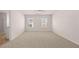 Expansive bedroom with carpet, two windows, and a ceiling fan at 290 Halibut Cir, Covington, GA 30016