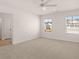 Carpeted bedroom bathed in sunlight, complete with a ceiling fan and neutral walls at 290 Halibut Cir, Covington, GA 30016