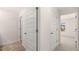 The carpeted hallway features multiple white panel doors and a view of the outside at 290 Halibut Cir, Covington, GA 30016
