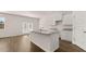 Modern kitchen featuring an island with a sink, granite countertops and stainless steel appliances at 290 Halibut Cir, Covington, GA 30016