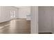 Open living room with wood flooring, French doors, closet, and kitchen view at 290 Halibut Cir, Covington, GA 30016