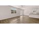 Bright, open living space with modern flooring, connecting to kitchen with granite counters at 290 Halibut Cir, Covington, GA 30016