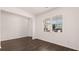 Bright room with neutral walls, hardwood floors and a large window providing natural light and neighborhood views at 290 Halibut Cir, Covington, GA 30016