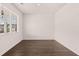 Bright, empty room with neutral walls, hardwood floors and a large window offering ample natural light at 290 Halibut Cir, Covington, GA 30016