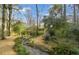 A meticulously landscaped backyard with a stream and bridge creates a peaceful outdoor oasis at 3063 Randolph Ne Rd, Atlanta, GA 30345