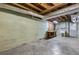 Unfinished basement with concrete floor, work bench, utility sink, and exposed ceiling at 3063 Randolph Ne Rd, Atlanta, GA 30345
