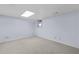 A finished basement area with neutral carpet and walls features a small window for natural light at 3063 Randolph Ne Rd, Atlanta, GA 30345