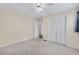 Neutral bedroom featuring carpet, ceiling fan, and closet with paneled doors at 3063 Randolph Ne Rd, Atlanta, GA 30345