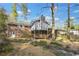 Rear exterior of home featuring beautiful landscaping and a multi-level deck for outdoor enjoyment at 3063 Randolph Ne Rd, Atlanta, GA 30345