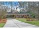 Inviting brick home featuring an extra-long driveway, a covered carport and lush front lawn at 3063 Randolph Ne Rd, Atlanta, GA 30345