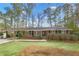 Charming brick home with mature trees, lush lawn and covered carport in a tranquil setting at 3063 Randolph Ne Rd, Atlanta, GA 30345