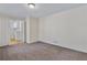 Living room features neutral paint, carpet, and entryway to kitchen at 3063 Randolph Ne Rd, Atlanta, GA 30345