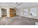 Open living room with vaulted ceilings, fan, large built-in cabinets and access to the backyard at 3063 Randolph Ne Rd, Atlanta, GA 30345