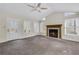 Spacious living area with vaulted ceiling, fireplace, fan and a door leading to outdoor deck at 3063 Randolph Ne Rd, Atlanta, GA 30345